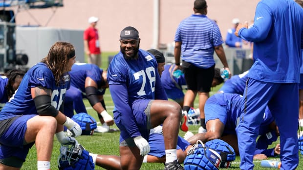 New York Giants offensive tackle Andrew Thomas (78) and guard Shane Lemieux (66) stretch at the end of the first day of training camp at Quest Diagnostics Training Center in East Rutherford on Wednesday, July 27, 2022.